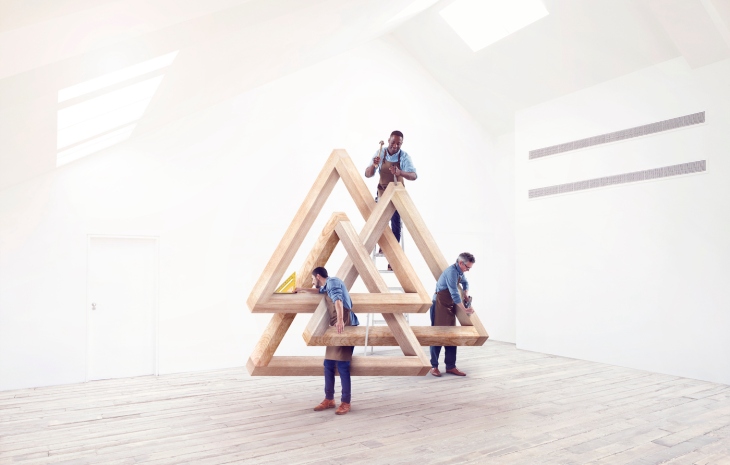 Designers working on an impossible triangle.