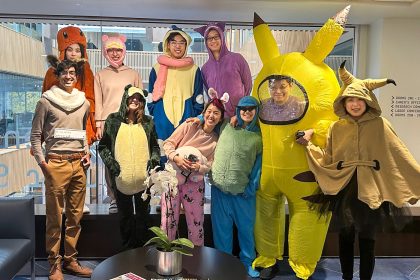 group of students and teachers posing in Halloween costumes