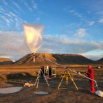 A weather balloon about to launch in a desert.