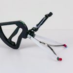 the training gripper sits on a table.