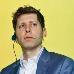 Man in blue blazer pictured against yellow background